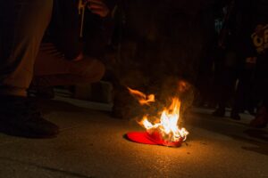 Make_America_Great_Again_hat_on_fire_outside_The_National_Press_Club_(32420564445)